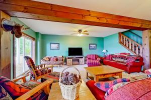 a living room with green walls and red furniture at American Dream on Lake Winnipesaukee in Meredith