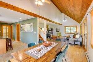 a dining room and living room with a wooden table and chairs at Charming Putney Home Porch, Grill and Hiking Trails in Putney