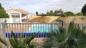 a swimming pool in a house with a fence at My Quiet Place near Carcassonne in Carcassonne