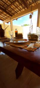 a wooden table with a table cloth on it at Casa mãe Terra in Camacari