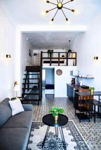 a living room with a couch and a table at Lofts At San Agustin in San Juan