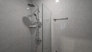a shower with a glass door in a bathroom at Big studio apt.on Liberty Square in Tbilisi City