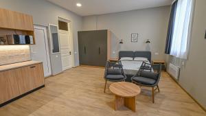 a living room with a couch and a table and chairs at Big studio apt.on Liberty Square in Tbilisi City +2 photos