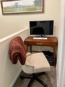 escritorio con silla y monitor de ordenador en The Blue Door at Sylva Home Base Apartments, en Sylva