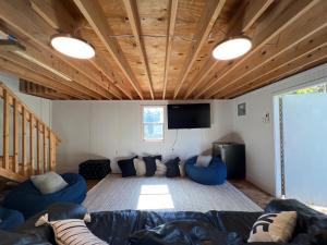 a living room with blue couches and a flat screen tv at 5BR 4B Huge Space with 2 Level Game Barn in Greenville