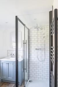 a bathroom with a shower and a sink at Charming Family Farmhouse near Lyme Regis in Axminster