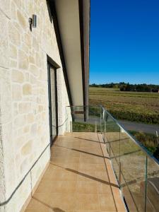 a walkway leading up to a building with a stone wall at Apartman Detvianka 1 in Detva