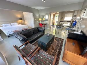 a living room with a couch and a bed at Green Point Self Catering Studios in Cape Town
