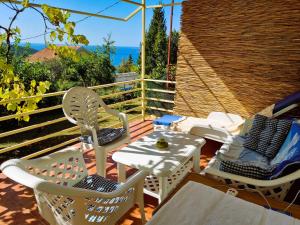 a patio with chairs and a table and an umbrella at Summer house Kruce in Kruče