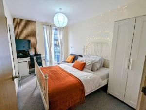 a bedroom with a large bed with an orange blanket at Canal Room in London
