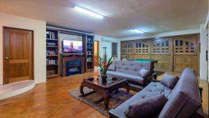 a living room with a couch and a table at Sea Treasure Villa in Puerto Vallarta