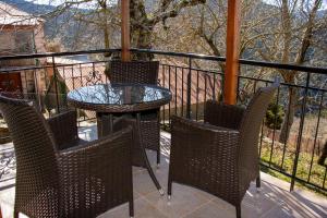 a patio with a table and chairs on a balcony at Private House, Miriki Village in Miríki