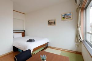 a small room with a bed and a table at Grace Heiwajima - Vacation STAY 15464 in Tokyo