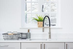 a kitchen sink with a dish basket on the counter at Charming Family Farmhouse near Lyme Regis in Axminster +51 photos