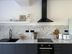 een keuken met een wastafel en een aanrecht bij Entire rental unit hosted by Lux Living in Oxford