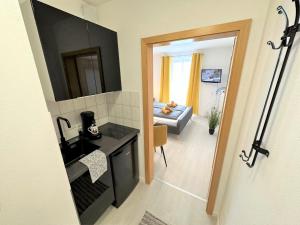 a room with a kitchen and a living room at Gemütliches Studio im Bayerwald +POOL +SAUNA +WIFI in Zwiesel