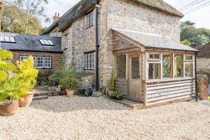 a greenhouse in the courtyard of a house at Charming Family Farmhouse near Lyme Regis in Axminster