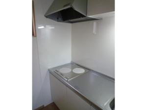 a small kitchen with white walls and a counter at Seaside Hostel Light House - Vacation STAY 82325v in Onomichi