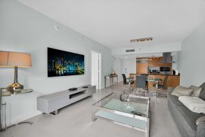 a living room with a couch and a table at Perfect One Bedroom at Icon Brickell Amazing views in Miami