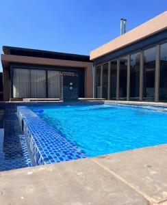 a swimming pool in front of a house at Villa 698 tswinga in Thohoyandou