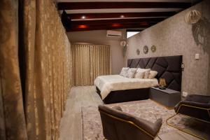 a bedroom with a bed and a couch in it at Villa 698 tswinga in Thohoyandou