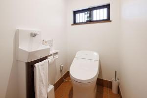 a bathroom with a toilet and a sink and a window at Sennichi House - Vacation STAY 20290v in Kanazawa