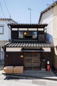 a building with two baskets sitting in front of it at Sennichi House - Vacation STAY 20290v in Kanazawa