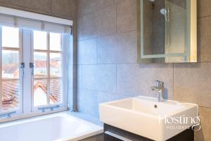 a bathroom with a white sink and a window at The Penthouse, Henley-On-Thames in Henley on Thames