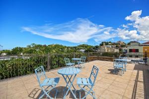 a patio with tables and chairs on a balcony at Rincon Plaza Hotel in Rincon +69 photos