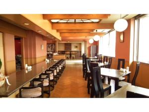 a restaurant with a row of tables and chairs at Hotel Montagne Matsumoto - Vacation STAY 82922v in Matsumoto