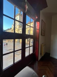 a room with a window looking out at a city street at Piso Ayuntamiento Los Candiles in Oviedo