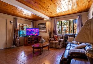 a living room with a couch and a tv at Huge Family - 5 bedroom sleeps 16 with private pool home in San Felipe