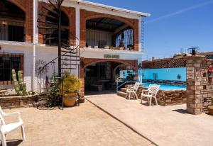 a patio with chairs and a swimming pool in a building at Huge Family - 5 bedroom sleeps 16 with private pool home in San Felipe