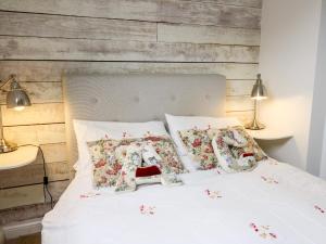 a bedroom with a white bed with two pillows at Buzzards Watch in Llandeilo
