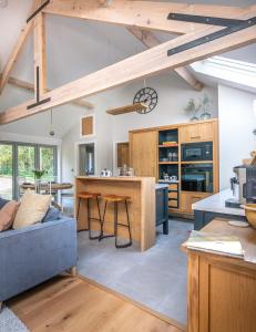a kitchen and living room with a blue couch at The Old Workshop, Corbridge in Corbridge