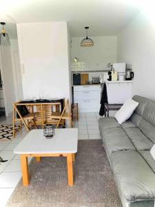 a living room with a couch and a table at Pontalife in Vaux-sur-Mer