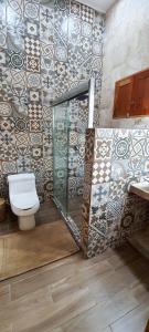 a bathroom with a toilet and a glass shower at VILLA UNAHANA in Valladolid