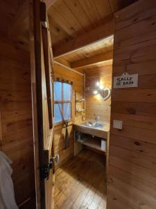 a bathroom with a sink in a log cabin at LES CHALETS DE VANESS' l'Eden in Digoin