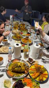 a long table with plates of food on it at Blue House Town in Chefchaouen