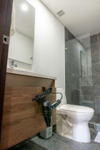 a bathroom with a toilet and a sink and a shower at Apartamento en Chapinero - 209 in Bogotá