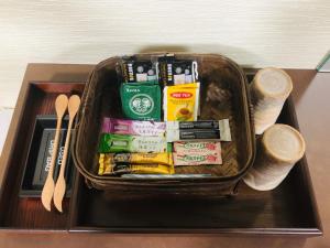 a basket on a table with packets and utensils at Kajitsu no mori - Vacation STAY 53766v in Ichinoseki