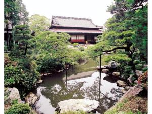 a river in front of a building in a garden at Kuwana Park Hotel - Vacation STAY 66850v in Kuwana