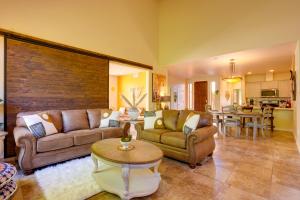 a living room with two couches and a table at Sedona Getaway with Sunlit Patio Near Bell Rock! in Sedona