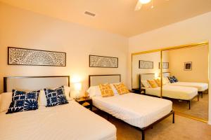 a bedroom with two beds and a mirror at Sedona Getaway with Sunlit Patio Near Bell Rock! in Sedona