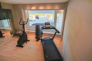 a gym with two exercise bikes and a treadmill at Villa do Vale Boutique Hotel in Blumenau +152 photos