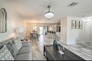 a living room with a couch and a table at Luxury modern home Heated pool best Location in Port Charlotte +3 photos