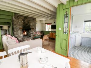 a living room with a table and a fireplace at Red Kite Lodge in Llandeilo