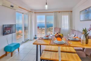 a living room with a table and a view of the ocean at Apollo Apart in Kaş