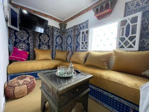 a living room with a couch and a table at Charming Cozy house kasbah in Tangier