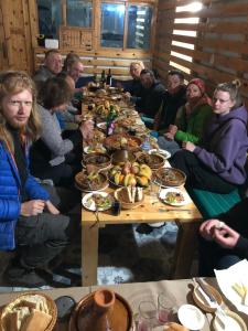 un grupo de personas sentadas alrededor de una mesa con comida en LAFAMILIA SURF imsouane en Imsouane